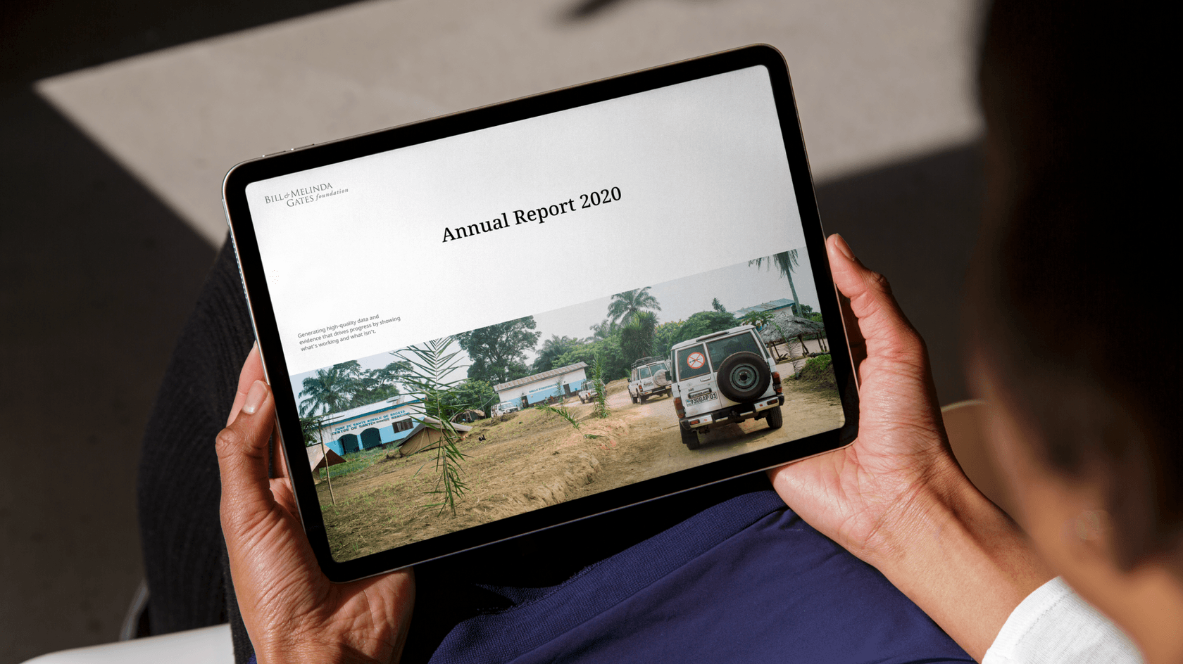 Tablet screen showing vehicle driving towards a rural health facility. Title reads Annual Report 2020.